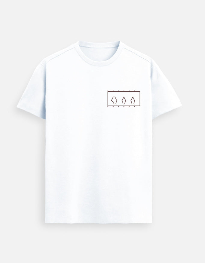 Woman standing inside a modern art museum wearing a White Supima cotton T-shirt by Lilak, featuring a minimal geometric design on the left chest